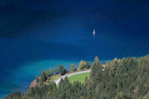 View over the deep blue and clear waters of Weissensee lake
