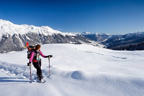 Snowshoe hiker during the ascent to Jagelealm alpine pasture