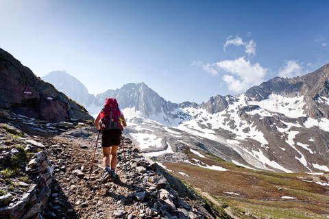 Hiker on the Merano High Mountain Trail ascending to Hohen Wilden Mountain in Pfossental valley
