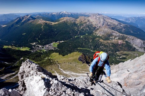 Mountaineers while climbing the Via Ferrata Bolver-Lugli climbing route on Cima Vezzena Mountain in the Pala Group