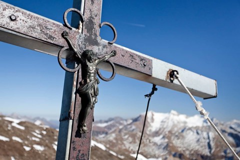 Summit cross on the summit of Wilden Kreuzspitze Mountain in the Pfunderer Mountains