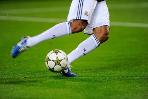 Real Madrid player running after the official match ball