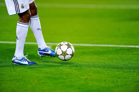 Real Madrid player running after the official match ball