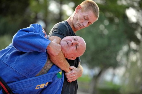 Two men doing martial arts in a park