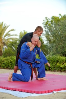 Two men doing martial arts training in a park