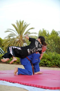 Woman and a man doing martial arts training in a park