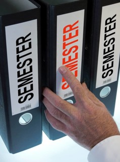 Hand reaching for a file folder labeled 'Semester'
