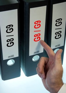 Hand pointing to a file folder labeled 'G8 - G9'