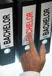 Hand pointing to a file folder labeled 'Bachelor'