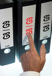 Hand pointing to a file folder labeled 'G8 - G9'