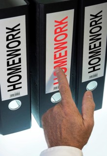 Hand pointing to a file folder labeled 'Homework'