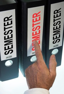 Hand pointing to a file folder labeled 'Semester'
