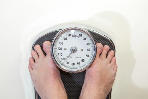 A man standing on bathroom scales