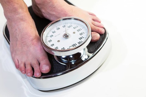 A man standing on bathroom scales