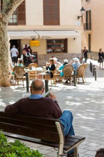 Spaniard reading a newspaper on Plaça de Santa Eulalia square