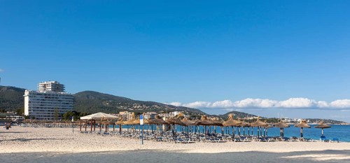 Section of beach near Palma Nova with sunbeds and hotels
