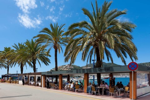 Outdoor restaurants with tourists at the bay of Puerto Andratx