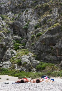 Tourists sunbathing in Torrent de Pareis Gorge