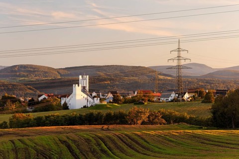 Church of St. Michael built in the early 1990s and power lines of the Hochrheinkraftwerke power plant