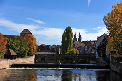 View from Kettensteg bridge past Maxbruecke bridge towards the Church of St. Lawrence