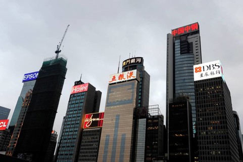 Skyscrapers and neon signs at dusk