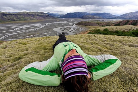 Young woman lying in a moss landscape