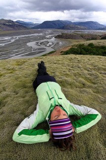 Young woman lying in a moss landscape