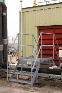 Steps giving access over roof top industrial plant pipework