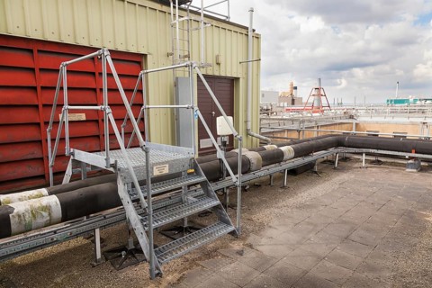 Steps giving access over roof top industrial plant pipework