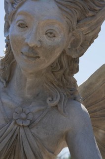 Close-up of a female like statue with wings in the Fairy garden at the 'Route des Gerbes d'Angelica' garden in Mirabel