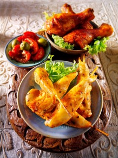 Party buffet food with chicken satay and BBQ drum sticks