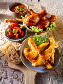 Party buffet food with chicken satay and BBQ drum sticks