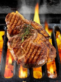 Sirloin beef steaks being cooked on a BBQ