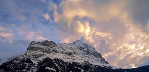 Sunset and clouds over the summit of the North Face of Eiger mountain