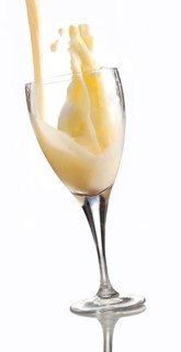 Fresh flavoured milk being poured into a glass