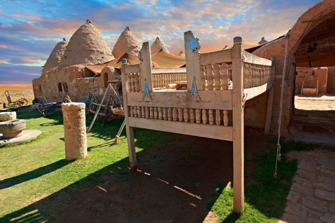 Beehive adobe buildings of Harran with a summer outdoor bed