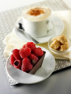 Chocolate cake filled with chocolate truffle and topped with fresh raspberries