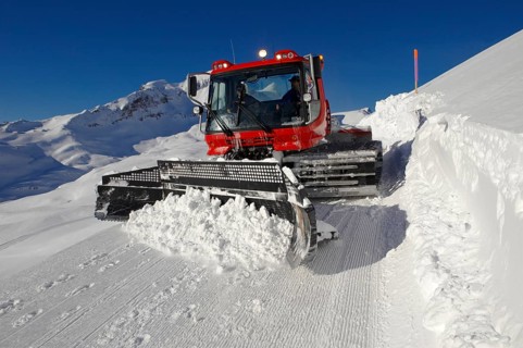 Snow groomer in winter in the mountains near Grindelwald First