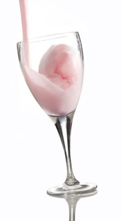Fresh flavoured milk being poured into a glass