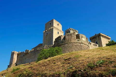 The medieval battlements of the Rocca Maggiore castle on the hilltop above Assisi