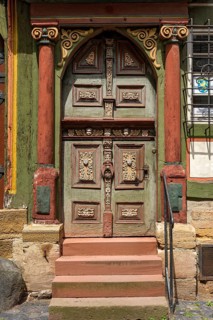 Renaissance door with painted wood carvings