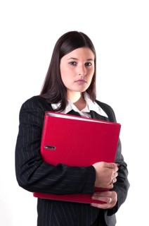 Businesswoman holding a red folder in her arm