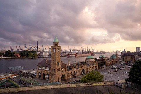 St. Pauli Landungsbrucken jetties with level tower and Blohm + Voss shipyard in Hamburg