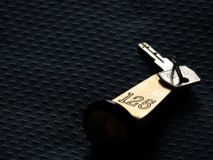 Hotel key lying on a hotel bed
