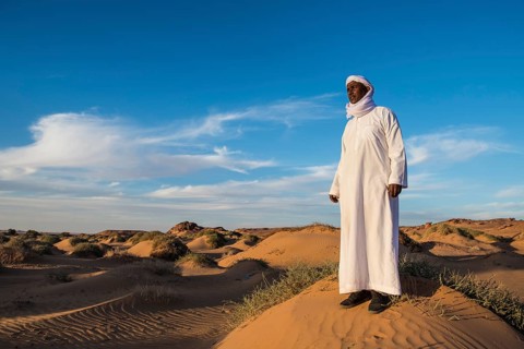 Beduin man in the desert in evening light