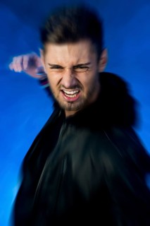 Aggressive young man with his hand prepared to strike