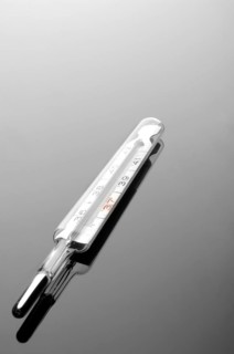 Mercury thermometer on a reflective surface