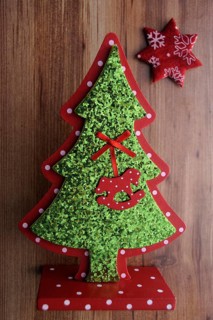 Miniature Christmas tree and a star on a wooden surface