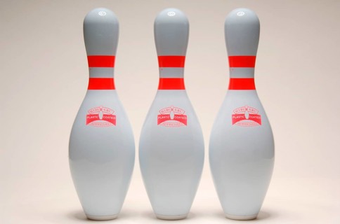 Three bowling pins lined up together