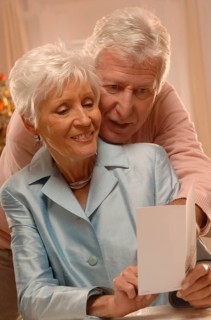 Mature couple reading Christmas cards